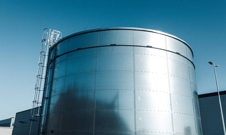metal industrial storage tank with a ladder leading up to the top