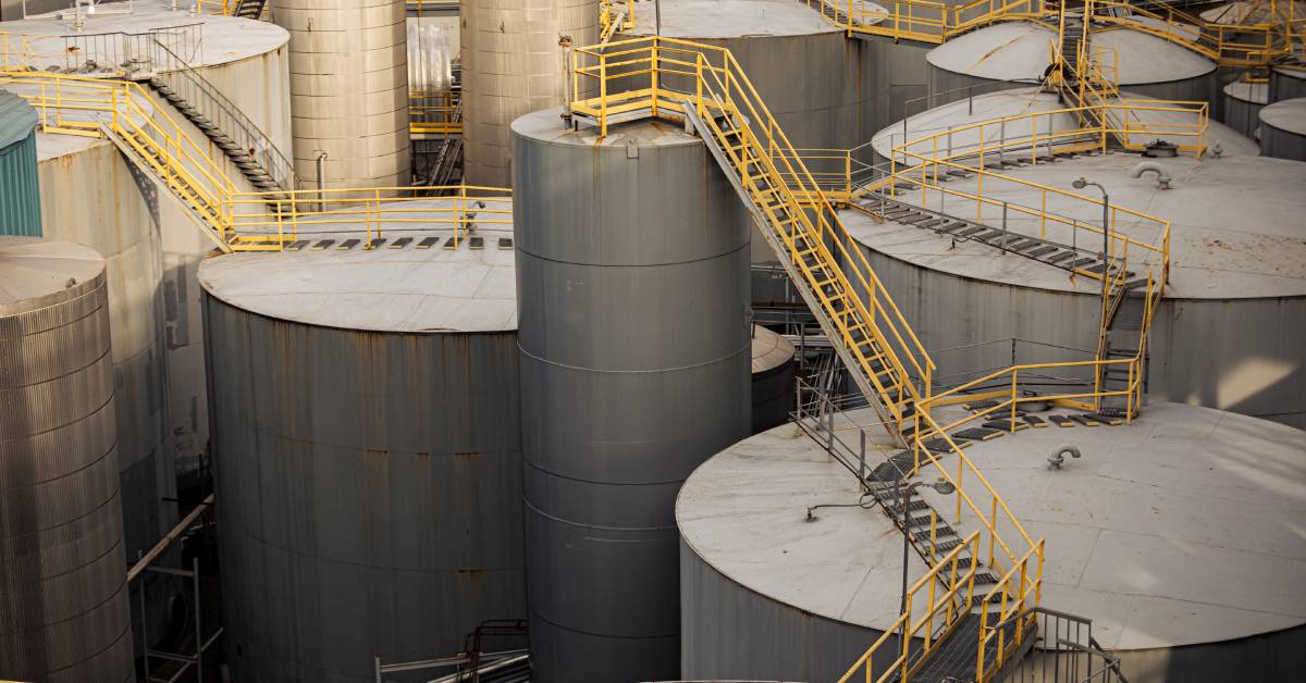 A large outdoor space with multiple storage tanks connected to each other by large walkways.